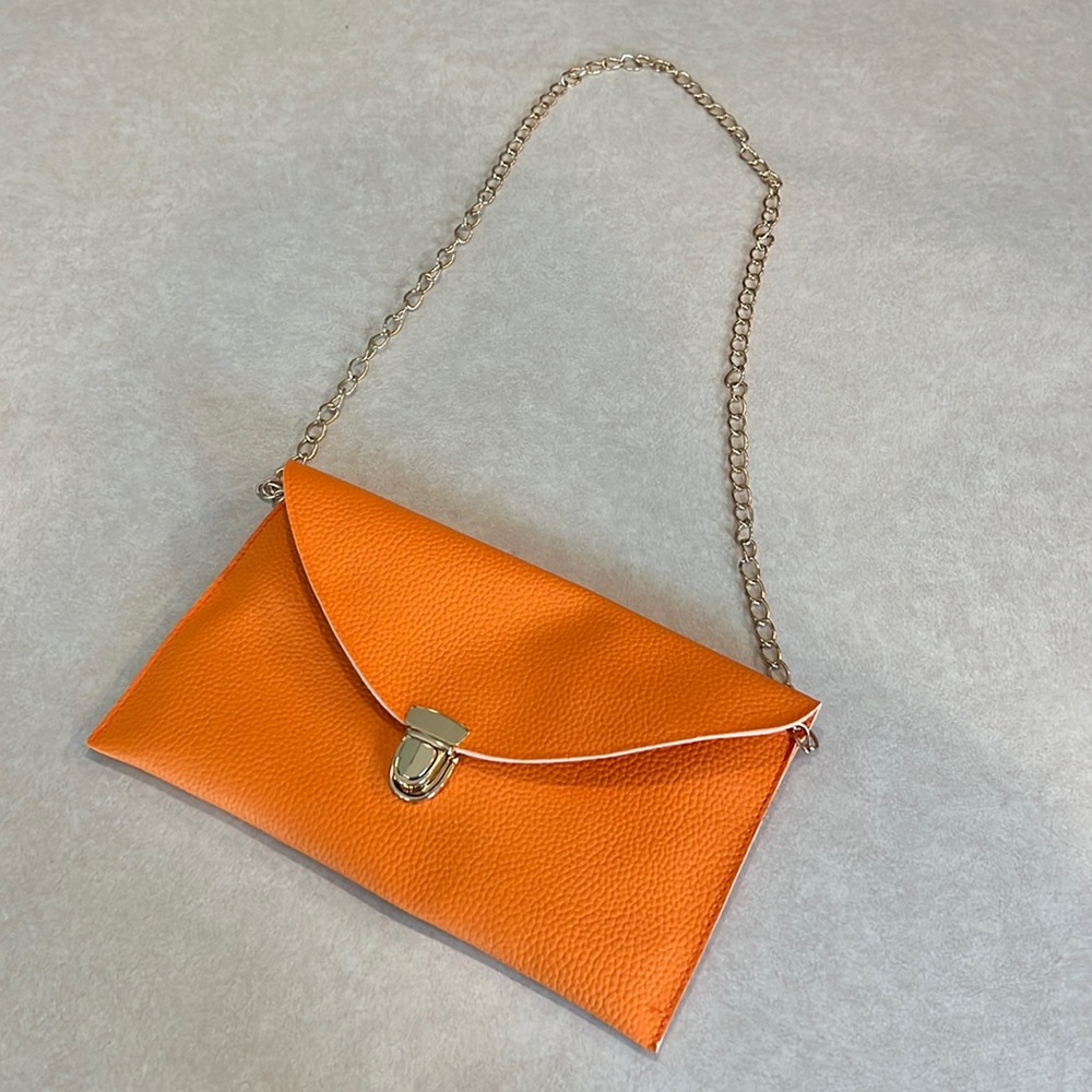 Basic orange clutch. Strap is removable. Gently used. Perfect for a night out